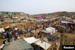 FILE - Rohingya refugees gather at a market inside a refugee camp in Cox's Bazar, Bangladesh, March 7, 2019.