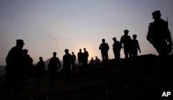 FILE - Pakistan army soldiers gather at a forward area post on the Line of Control that divides Kashmir between Pakistan and India, in Tatta Pani, 200 kilometers from Islamabad, Pakistan, Oct. 1, 2016.