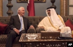 FILE - U.S. Secretary of State Rex Tillerson meets with the emir of Qatar, Sheikh Tamim bin Hamad Al Thani, at the Sea Palace in Doha, Qatar, July 11, 2017.