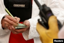 A search and rescue volunteer takes notes while combing through areas destroyed by the Camp Fire in Paradise, California, U.S., Nov. 13, 2018.