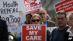 FILE - Supporters of the Affordable Care Act, who are also opponents of Colorado's GOP-led plan to undo Colorado's state-run insurance exchange gather for a rally organized by the national Save My Care Bus Tour, on the state Capitol steps in Denver, Feb. 