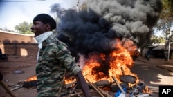 FILE - Protesters take to the streets of Burkina Faso's capital, Ouagadougou, Nov. 27, 2021, calling for President Roch Marc Christian Kabore to resign. 