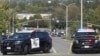 Police cars are seen after a deadly shooting at Geneva Presbyterian Church in Laguna Woods