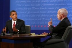 FILE - Then-Democratic presidential candidate Senator Barack Obama, and then-Republican presidential candidate Senator John McCain, talk during a presidential debate, October 15, 2008, at Hofstra University in Hempstead, New York.
