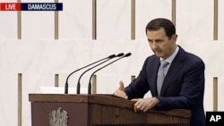 Syrian President Bashar Assad delivering a speech in Damascus, Syria, Sunday. This image is made from video broadcast on Press TV, Iran's English language state-run channel, July 26, 2015.