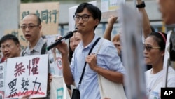 Land reform campaigner Eddie Chu, center, speaks as he thanks his supporters for their vote in the legislative elections in Hong Kong, Sept. 10, 2016.