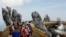 Tourists walk along Gold Bridge on Ba Na hill near Danang city, Vietnam, Aug. 1, 2018. 