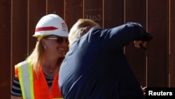 U.S. President Donald Trump signs his signature on the border wall while visiting a section of the U.S.-Mexico border wall in Otay Mesa, California, Sept. 18, 2019. 