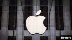 FILE - An Apple logo hangs above the entrance to the Apple store on 5th Avenue in the Manhattan borough of New York City, July 21, 2015. 