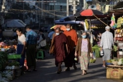 People walk at a market after the army seized power in a coup in Yangon, Myanmar, Feb. 2, 2021.