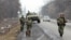 FILE - Interior Ministry officers patrol a road in the Russian North Caucasus on the hunt for Islamic State rebels, Jan. 28, 2011.