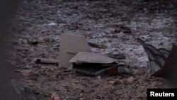 Parts of the drone are seen at the site of a building destroyed by a Russian drone attack, as their attack on Ukraine continues, in Kyiv, Ukraine Dec. 14, 2022. 