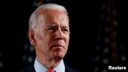  FILE PHOTO: Democratic U.S. presidential candidate and former Vice President Joe Biden speaks about responses to the COVID-19 coronavirus pandemic at an event in Wilmington, Delaware, U.S., March 12, 2020. 