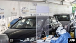 Egyptians get tested for Covid-19 at a drive-through coronavirus-testing center at the Ain Shams University in Cairo, June 29, 2020.