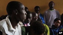Teenage Orphans listen as officials explain that the Noel Orphanage will be downsized, and they will be relocated.