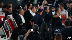 High court judge Azmi Ariffin, right in the middle, visits the check-in kiosk at Kuala Lumpur International Airport in Sepang, Malaysia, Oct. 24, 2017. 