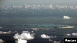 FILE - An aerial photo taken May 11, 2015, from a Philippine military plane shows the alleged ongoing land reclamation by China in the Spratly Islands region of the South China Sea, west of Palawan, Philippines.