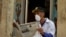 A man reads a newspaper as he wears a face mask in Havana, on March 12, 2020 as the world battles the outbreak of the new coronavirus, COVID-19.