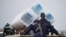 FILE - A policeman sits atop a minibus carrying empty ballot boxes to a central counting center in Democratic Republic of Congo's capital Kinshasa.