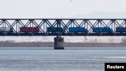 裝滿貨物的卡車駛過橫跨中國丹東和北韓新義州之間的鴨綠江上的友誼橋。 （資料照片）
