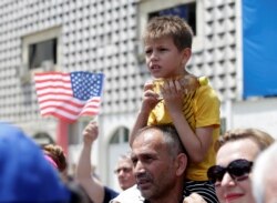 A boy looks on during the 20th anniversary of the deployment of NATO Troops in Kosovo in Pristina, Kosovo, June 12, 2019.