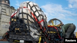 FILE - U.S. Navy sailors prepare material recovered in the Atlantic Ocean from a high-altitude Chinese balloon on Feb. 10, 2023 in this image released by the U.S. Navy in Washington, Feb. 13, 2023. 
