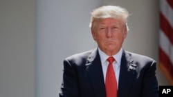 President Donald Trump stands next to the podium after speaking about the U.S. role in the Paris climate change accord in the Rose Garden of the White House in Washington, June 1, 2017. 