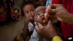 FILE - A Somali baby receives a polio vaccine at the Medina Maternal Child Health center in Mogadishu, Somalia, April 24, 2013. 