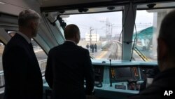 Presiden Rusia Vladimir Putin menaiki kereta api yang melintasi jembatan yang menghubungkan Rusia dan semenanjung Krimea (foto: ilustrasi). 