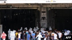 Migrants board the 'MS GNV Azzurra' quarantine ship which has has been sent on the Italian Pelagie Island of Lampedusa, Aug. 4, 2020, amid the COVID-19 pandemic