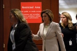FILE - House Speaker Nancy Pelosi is seen walking with aides on Capitol Hill in Washington, Oct. 17, 2019.