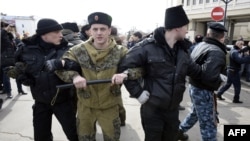 Pro-Russian volunteers stand guard in front of Crimea's parliament building during a pro-Russian rally in Simferopol, March 6, 2014.