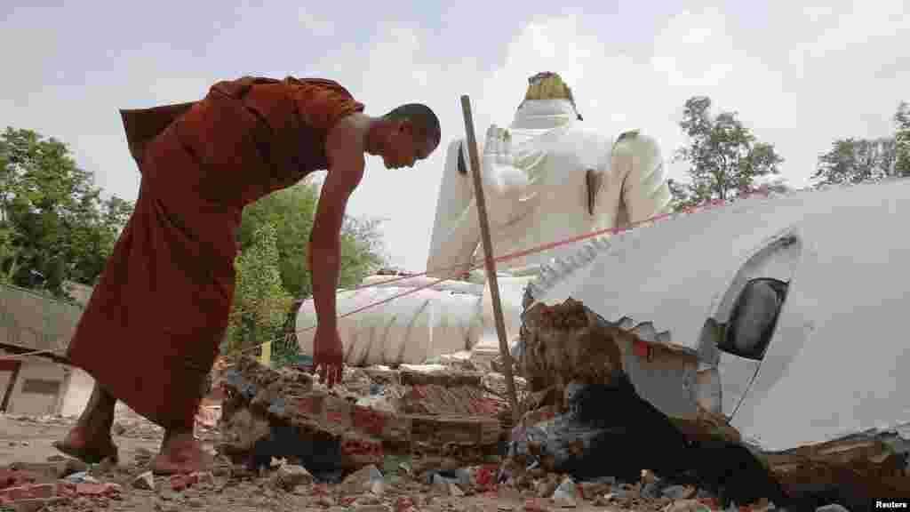 A Buddhist monk checks a statue of&nbsp;Buddha that was damaged by an earthquake at the Udomwaree temple in Chiang Rai, northern Thailand, May 6, 2014.