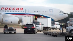 Vehicles pull up to a Russian aircraft to load freight at Dulles International Airport Dec. 31, 2016, in Sterling, Virginia, just outside Washington, D.C. The special flight arrived to pickup Russian diplomats expelled by U.S. President Barack Obama as part of sanctions imposed on Russia for suspected cyberhacking during the U.S. election.