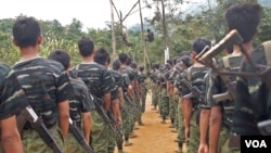FILE - Arakan Army recruits scale climbing ropes at their Laiza, Kachin state, base camp.