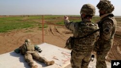 American and Spanish trainers use live ammunition in training exercises at Basmaya base, 40 kilometers southeast of Baghdad, Iraq. Intelligence assessments approved by senior leaders at U.S. Central Command exaggerated the progress of anti-terrorism efforts they ran against Islamic State militants.