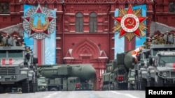 Russian military vehicles including Yars intercontinental ballistic missile systems drive along Red Square during a parade on Victory Day, which marks the 76th anniversary of the victory over Nazi Germany in World War II, in Moscow, May 9, 2021.