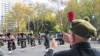 A veteran records a band with his phone as Australian military personnel, past and present, commemorate ANZAC Day during a march through the city center in Sydney, Australia, April 25, 2021. Many Australians and New Zealanders consider it one of the most sacred days of the year.