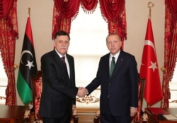 Turkish President Tayyip Erdogan meets with Libya's U.N.-recognized Prime Minister Fayez al-Sarraj in Istanbul, Turkey, Jan. 12, 2020.