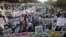 FILE - Students chant slogans while holding banners and posters showing Mumtaz Qadri, the alleged killer of Punjab governor Salman Taseer, during a rally to protest against any attempts to modify blasphemy laws, in Karachi, Pakistan, Jan. 20, 2011. Pakistani authorities on Feb. 29, 2016, hanged Qadri, a former police bodyguard. 