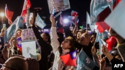 Supporters wave Taiwan's national flags and Taiwan People's Party (TPP) flags during an election campaign rally in Keelung on Jan. 10, 2024.