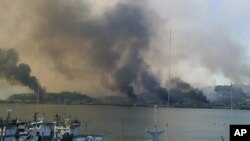 Smoke billow from Yeonpyeong island near the border against North Korea, in South Korea, 23 Nov 2010