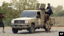 This still image taken from video provided by Arab 24 shows Saudi-led forces fighting to retake the international airport of Yemen's rebel-held port city of Hodeida from Shiite Houthi rebels, June 16, 2018.