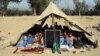 Afghan students attend a school class under a tent in Jalalabad, capital of Nangarhar province, Dec. 16, 2015. According to Afghan Ministry of Education estimates, around 33,000 students have been deprived of education in 58 schools in the Achin, Haskamena, and Kot districts of Nangarhar province.
