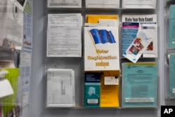 FILE - Voter registration materials are displayed at City Hall in Kaktovik, Alaska, Oct. 14, 2024.