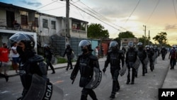 Riot police walk the streets after a demonstration against the government of President Miguel Diaz-Canel in Arroyo Naranjo Municipality, Havana, July 12, 2021.