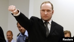 Norwegian mass killer Anders Behring Breivik gestures as he arrives at the court room in Oslo Courthouse August 24, 2012. 