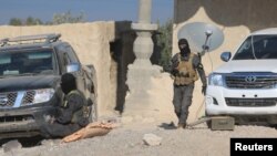 Kurdish fighters from the People's Protection Units (YPG), who are fighting alongside the Syrian Democratic Forces, are seen at the eastern entrance of the Tishrin Dam, after they captured it from Islamic State militants, south of Kobani, Syria, Dec. 27, 2015.