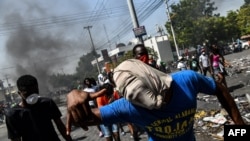 Protesters march on the street to demand the resignation of President Jovenel Moise in Port-au-Prince, Haiti, Oct. 11, 2019.
