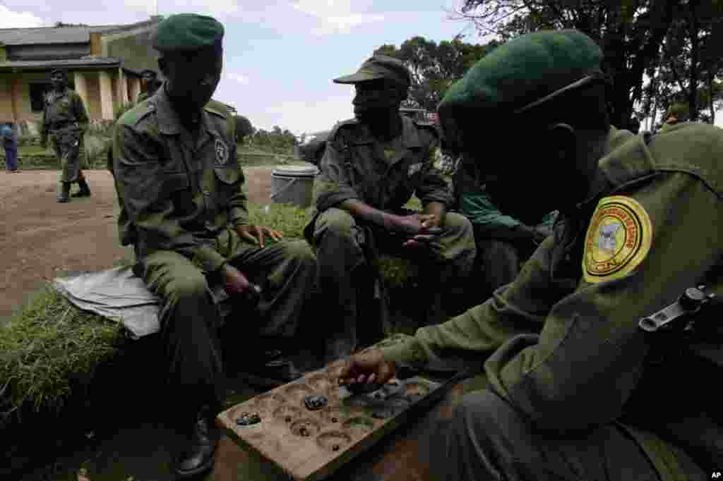 Virunga rangers play a traditional board game between park duties in 2007. Their primary responsibilities are protecting the wildlife. Twenty have been killed in confrontations with poachers and militias in the last three years.